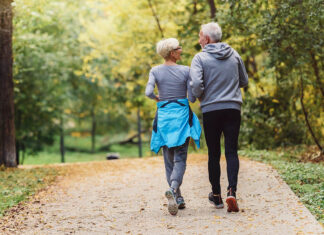 Better mental, physical health in older people tied to living near nature | WSU Insider A senior couple jogging side by side through a wooded park.