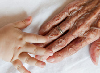 Med’s Kenneth Koncilja recommends strength training exercises for slower aging Photo of a grandparent and child's hands