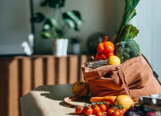 My Experience Using ChatGPT for Meal Prep Was More Than a Money-Saver Eco-friendly reusable shopping bag with multi-coloured fresh vegetables and groceries on the table at home