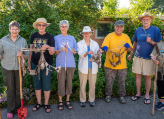 Programs bump prospective residents up on wait lists, support healthy aging gardeners holding gardening tools