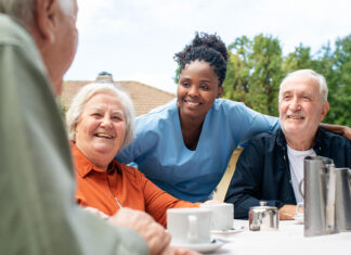 Assisted living quality, affordability among points raised in initial feedback on National Plan on Aging framework Nurse attends to socializing seniors on balcony at retirement home. Senior residents sit on a retirement home balcony, engaging in conversation while a female nurse stands by.
