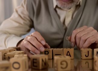 Social and health disparities drive brain aging in Latin America Male pensioner trying to make word of wooden cubes.