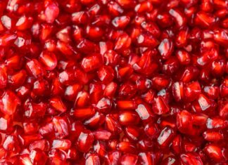 Reducing cardiometabolic risk and inflammation with pomegranate Delicious red ripe juicy pomegranate seed background texture.