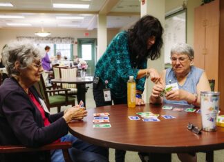 The best and worst N.H. communities for aging From left: Anne, Joan and Kathleen play a card game at the adult day care program at Easterseals in Manchester, N.H. on June 9, 2023.