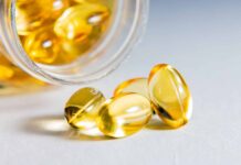 Omega-3 supplements linked to faster cognitive decline in older adults in a study An older adult looking thoughtful while considering a variety of health supplements, including omega-3 fish oil capsules.