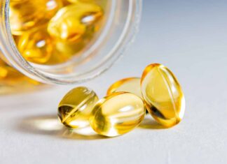 Omega-3 supplements linked to faster cognitive decline in older adults in a study An older adult looking thoughtful while considering a variety of health supplements, including omega-3 fish oil capsules.