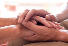 What is mental health? | Heart Foundation A man's hand stroking the hands of another in support
