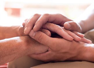 What is mental health? | Heart Foundation A man's hand stroking the hands of another in support