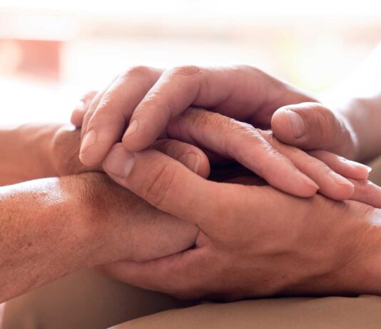 What is mental health? | Heart Foundation A man's hand stroking the hands of another in support